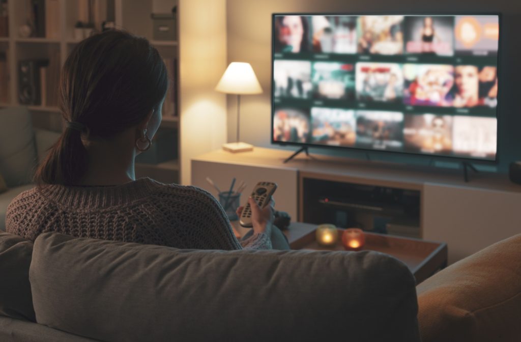 Person sitting in front of a TV