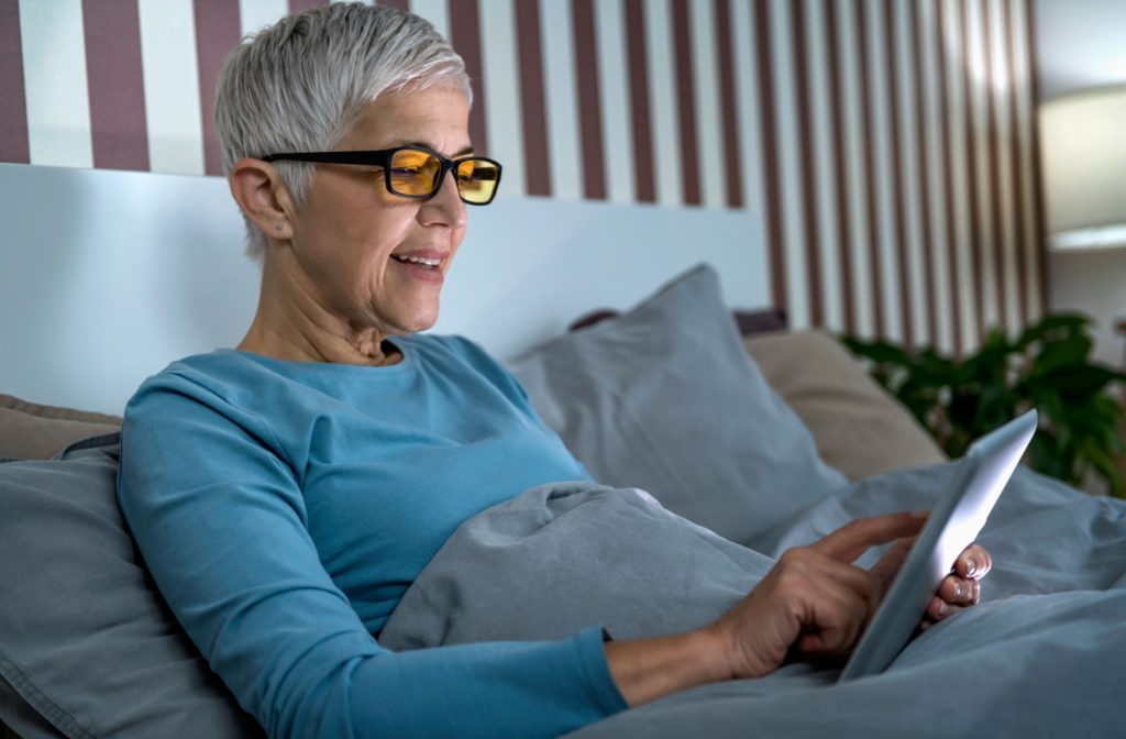 Person wearing glasses while using a tablet.