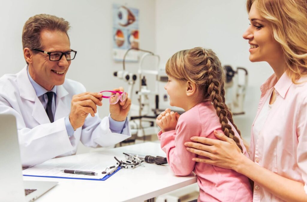 A young patient and their parent learn how myopia control glasses work from their eye doctor.