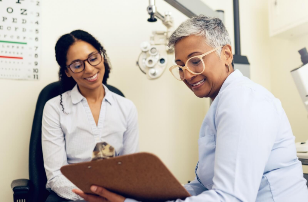 An optometrist and their patient discuss a dry eye treatment plan together.